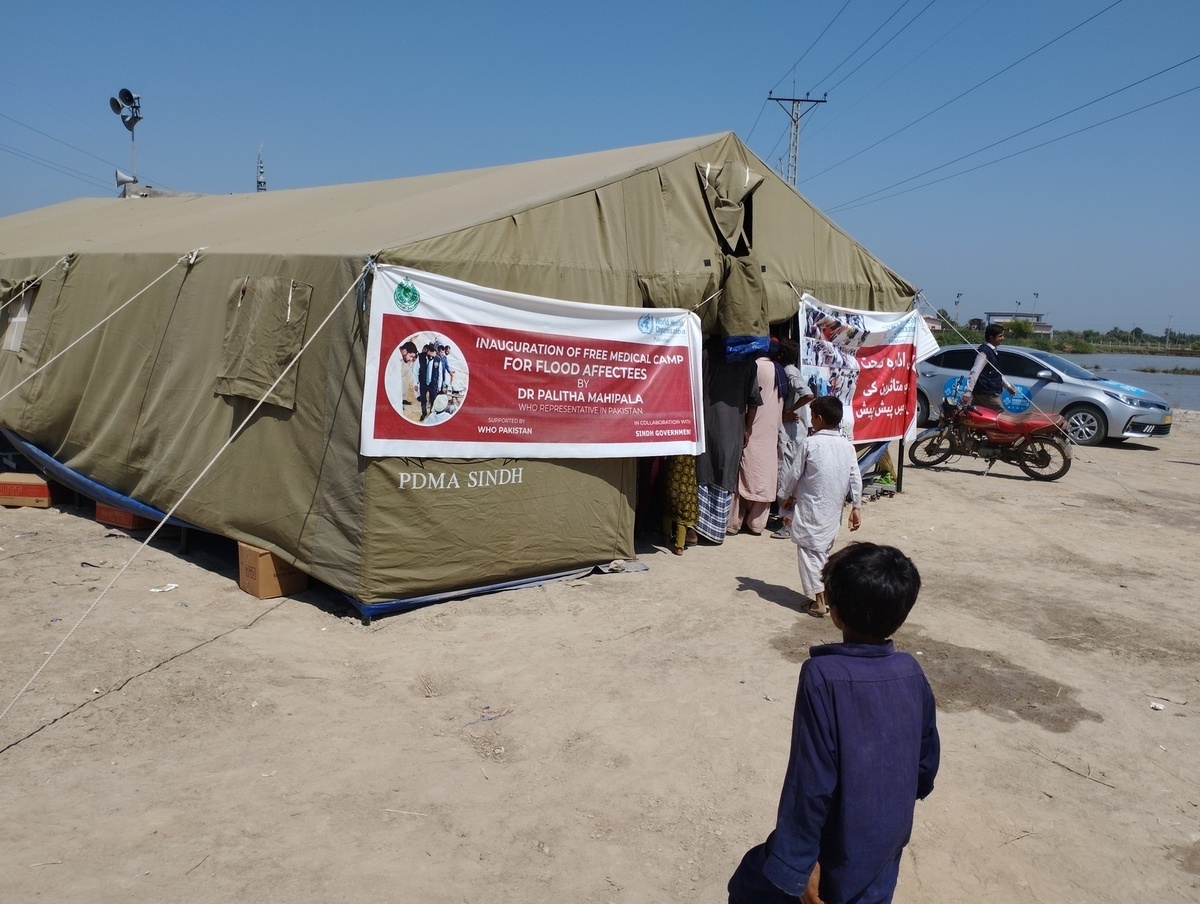 WHO delegation field visit to Larkana Internally Displaced Person (IDP) clinic .   A delegation from World Health Organization (WHO) led by Dr Mike Ryan, Executive Director, WHO Health Emergencies Programme along with WHO Representative in Pakistan, Dr Palitha Mahipala and WHO/EMRO Emergency Director, Dr Richard Brennan visited Pakistan and met with partners and the government to assess the needs and how best WHO can respond.   WHO is supporting the Government of Pakistan to respond by delivering supplies needed by health facilities and increasing disease monitoring to prevent the spread of infectious diseases. Devastating flash floods have washed away roads, homes and crops in Pakistan. The flooding was brought on by monsoon rains which began in mid-July 2022. The catastrophic floods killed over 1,400 people, destroyed more than half a million homes and displaced over 660,000 people into camps. Many more people are displaced in host communities. More than 750,000 livestock – a critical source of income for many families – died after the rainfall, which in August was more than five times the national 30-year average in some parts of Pakistan.  According to the Food and Agriculture Organization, the floods damaged 1.2 million hectares of agricultural land in Sindh Province alone. Some 33 million people have been affected, and access to many vulnerable communities was cut off as hundreds of bridges and thousands of kilometers of roads were destroyed or washed away.  https://www.who.int/news/item/17-09-2022-who-director-general-s-statement-on-pakistan--17-september-2022 - Title of WHO staff and officials reflects their respective position at the time the photo was taken.