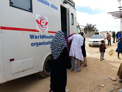 With support from the United States Office of State for Disaster Assistance (OFDA), the World Health Organization (WHO) has established and deployed four Emergency Mobile Medical Teams (EMT) to Benghazi, Ajdabiya, Tarhuna, Tawerga and Bani Walid to respond to urgent needs. For displaced families, illegal immigrants and vulnerable host communities. Each of the teams consists of a general practitioner, dermatologist, gynecologist, and pediatrician. Since the launch of the Mobile Emergency Medical Teams project in January, more than 5,000 patients have been treated, most of them in camps hosting displaced populations. These teams were established as part of the WHO's broader goal of providing a basic package of health care services covering the various components of the Minimum Health Service Package (MSP). WHO is also providing medical supplies and essential medicines to these teams and referral hospitals to ensure continuity of access to health services at all levels.