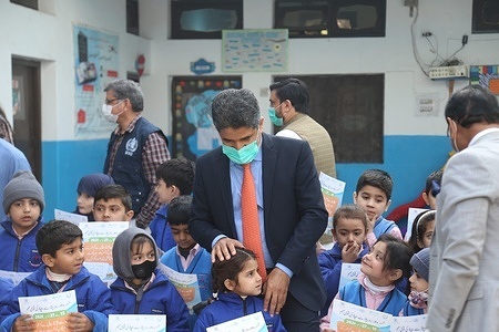 During his visit, WHO’s Regional Director for the Eastern Mediterranean Dr Ahmed Al-Mandhari visited a fixed vaccination site and a school (outreach site) at Gulbahar Colony in Peshawar to witness a nationwide measles and rubella campaign. The campaign is the largest in Pakistan's history and aims to vaccinate 90 million children (9 months to less than15 years) in Pakistan from 15 to 27 November 2021. Children posed with WHO Regional Director for the Eastern Mediterranean, Dr Ahmed Al-Mandhari. http://www.emro.who.int/pak/pakistan-news/who-regional-director-visits-pakistan-during-measles-and-rubella-campaign-and-inaugurates-community-covid-19-vaccination-centre.html - Title of WHO staff and officials reflects their respective position at the time the photo was taken.