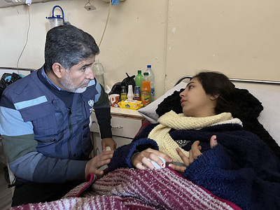 Dr Ahmed Al Mandhari, WHO regional Director for the Eastern Mediterranean listens to a young woman injured by the earthquake in Latakia, Syria. On 6 February 2023, a series of large earthquakes hit southern Türkiye and northern Syria, followed by hundreds of aftershocks. Thousands of lives were lost in the initial earthquakes and thousands more are at risk given the destruction of infrastructure and freezing temperatures in the affected areas. Efforts in the immediate aftermath of the earthquakes and the following days are focused on search and rescue, finding survivors among the rubble of collapsed buildings. Other urgent needs are providing medical care for people with physical injuries and ensuring food, drinking water and shelter for all those who have lost their homes. Ensuring continuous access to basic health services is also critical. Since the earthquake hit Syria, WHO has been providing supplies and working with health officials to direct medical teams and support to where they are most needed. WHO has also released more than US$ 16 million from the Contingency Fund for Emergencies, including US$ 3 million within hours of the disaster, in both Türkiye and the Syrian Arab Republic.  