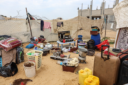 Internally displaced Palestinians staying in shelters in Rafah camp in the southern Gaza Strip  