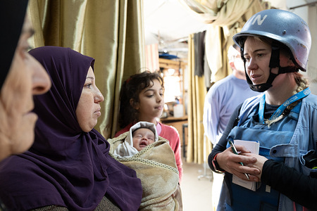 Joint mission WHO, OCHA, UNRWA and UNDSS to Al Amal PRCS hospital in Khan Younis. Caroline Logan, UNRWA discusses with mother holding six day old baby born in the hospital