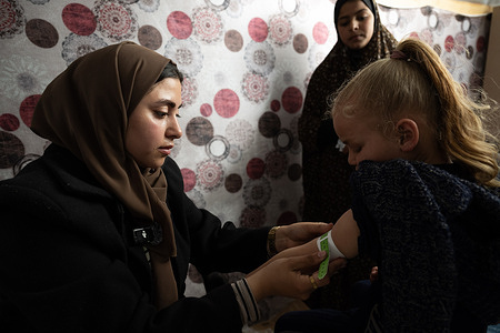 Mid-upper arm circumference (MUAC) screening for malnutrition in children at the Al-Dawa medical point, run by EMT partner Med global, west of Rafah. 